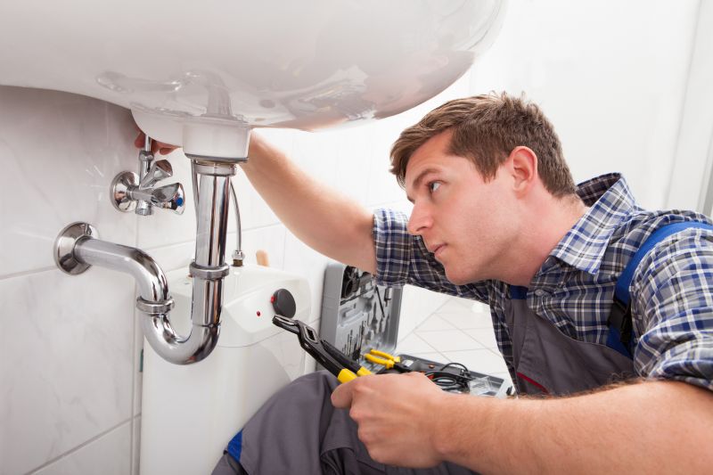 Plumber working on a sink